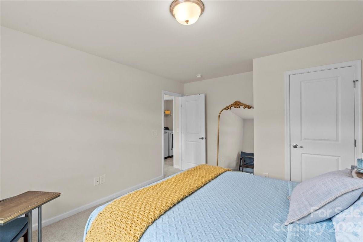 1662 Callahan Road Fort Mill, SC 29715 - Photo 37 of 42 a bedroom with a bed and a chandelier