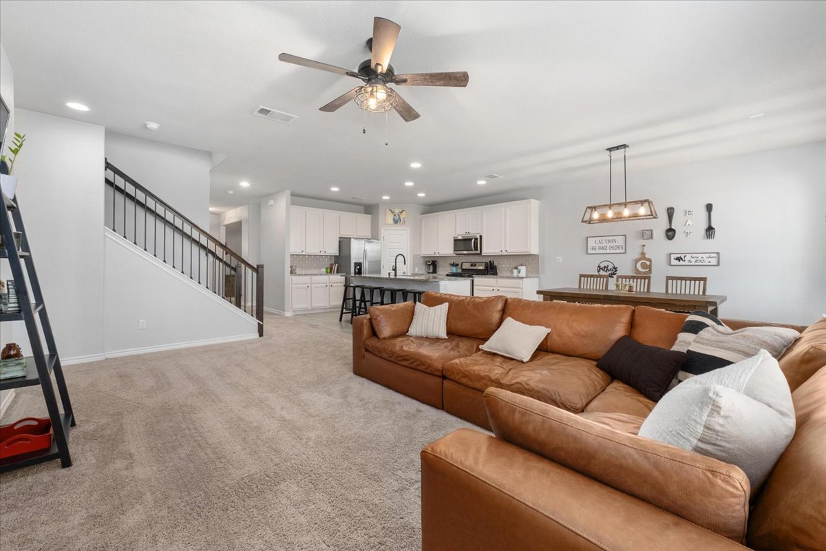 5408 Vanner Path Georgetown, TX 78626 - Photo 12 of 34 Open-concept living area featuring a ceiling fan, recessed lighting, and carpeted flooring