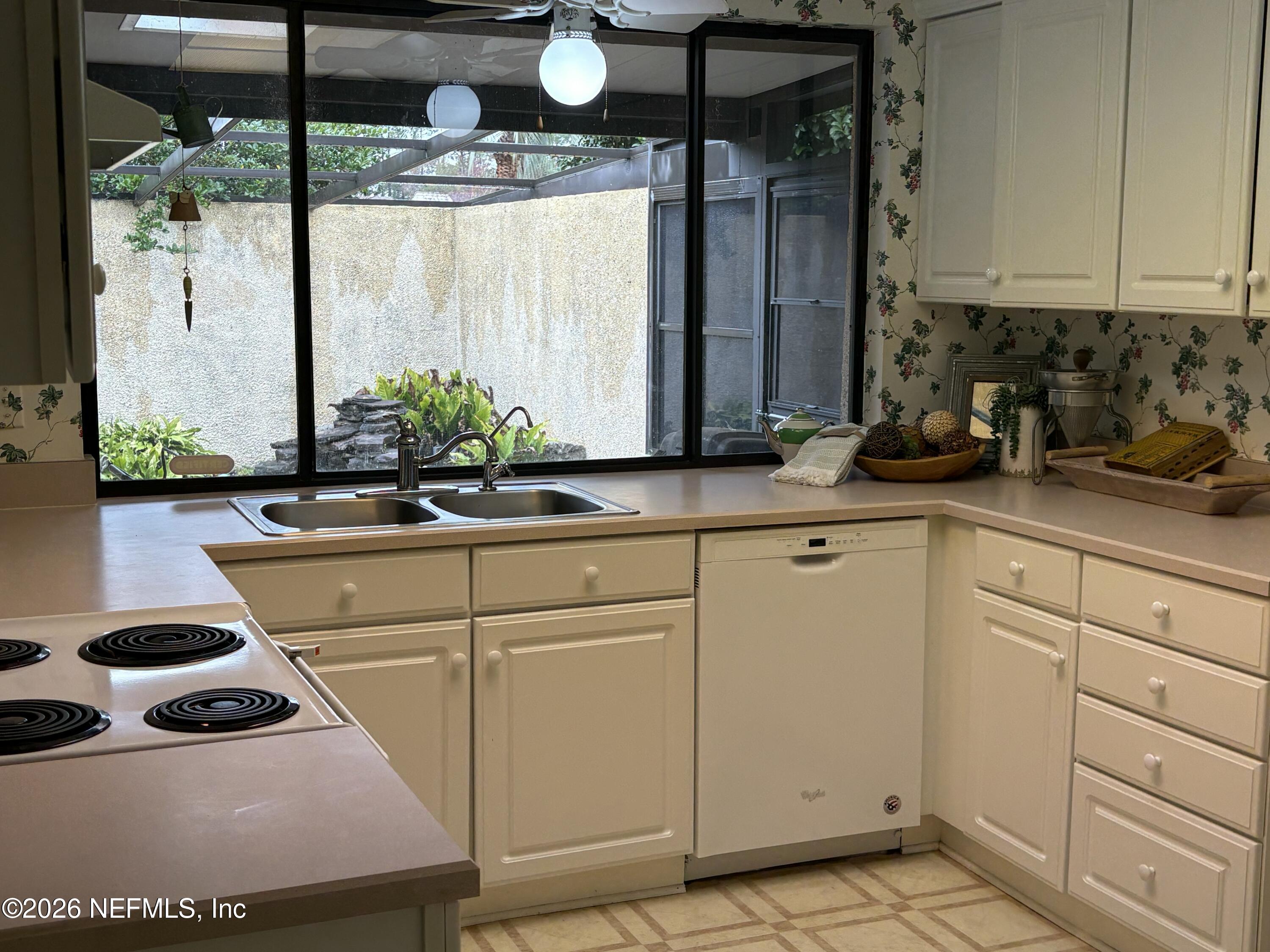 3411 Waverly Dock Road Jacksonville, FL 32223 - Photo 6 of 6 a kitchen with a sink and white cabinets