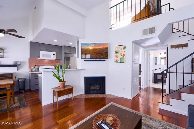 a living room with furniture fireplace and flat screen tv