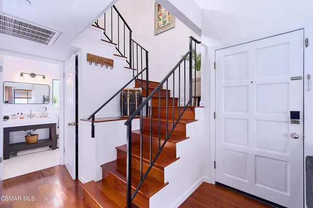 a view of entryway dining room and hall with wooden floor