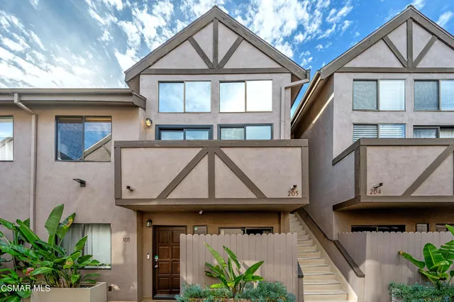 a view of a house with a window and wooden fence