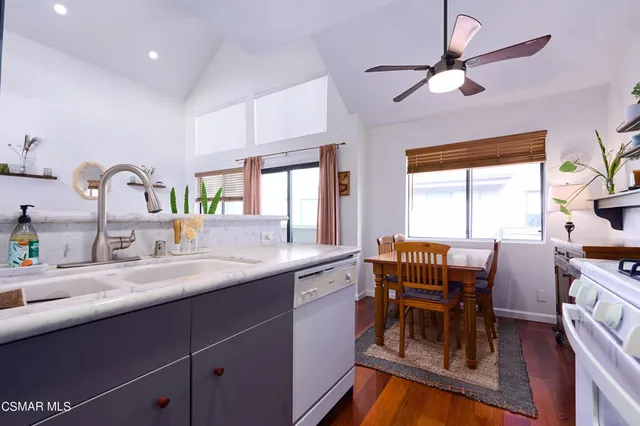 a kitchen with a table chairs sink and cabinets