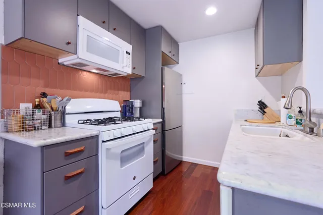 a kitchen with stainless steel appliances granite countertop a stove and a sink
