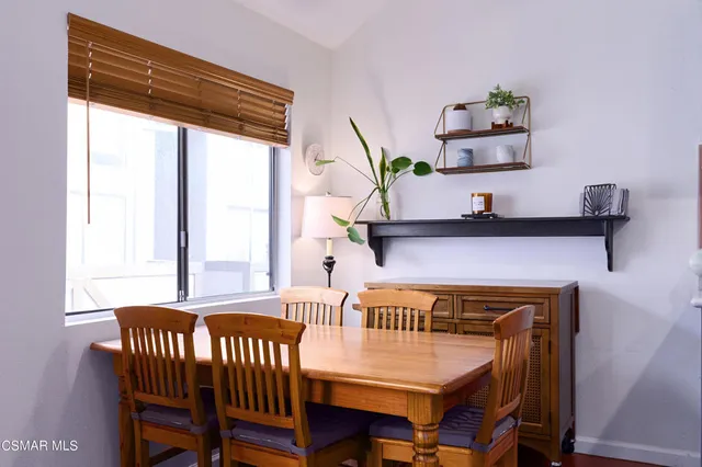 a view of a dining room with furniture and a window