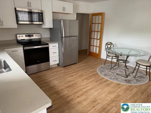 a kitchen with kitchen island a stove a sink and a refrigerator