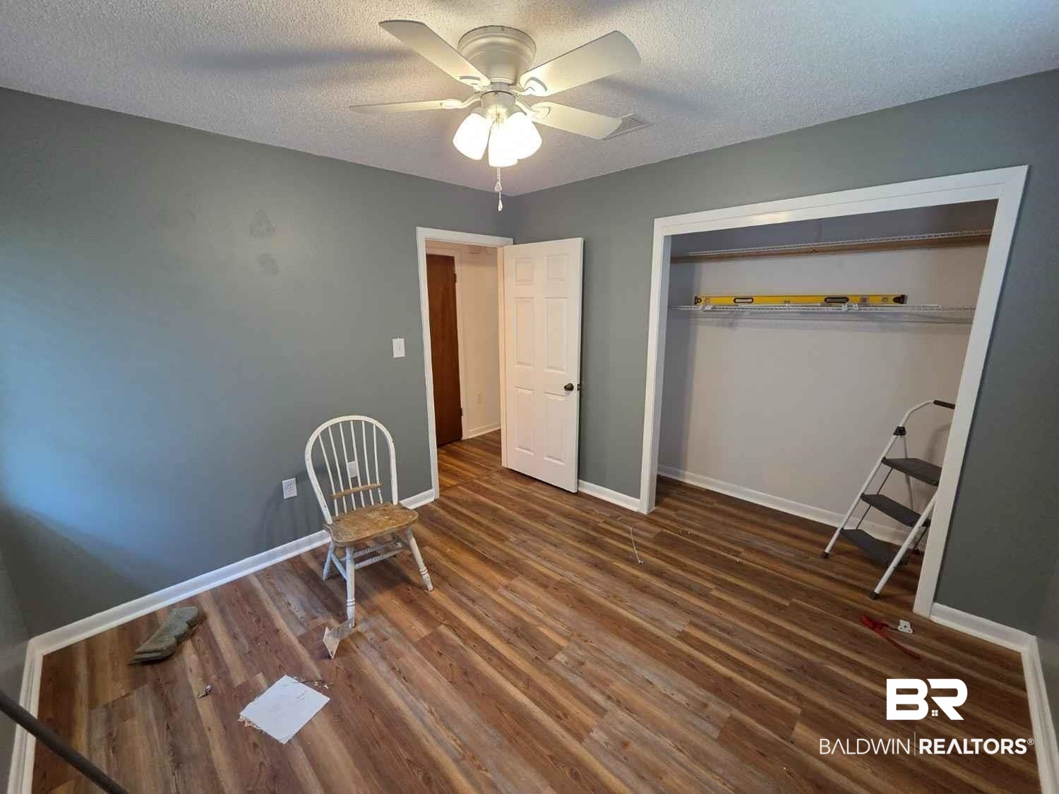 106 West 16th Street Bay Minette, AL 36507 - Photo 18 of 19 Unfurnished bedroom featuring wood finished floors, a textured ceiling, baseboards, a ceiling fan, and a closet
