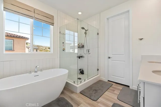 a white bath tub sitting next to a shower