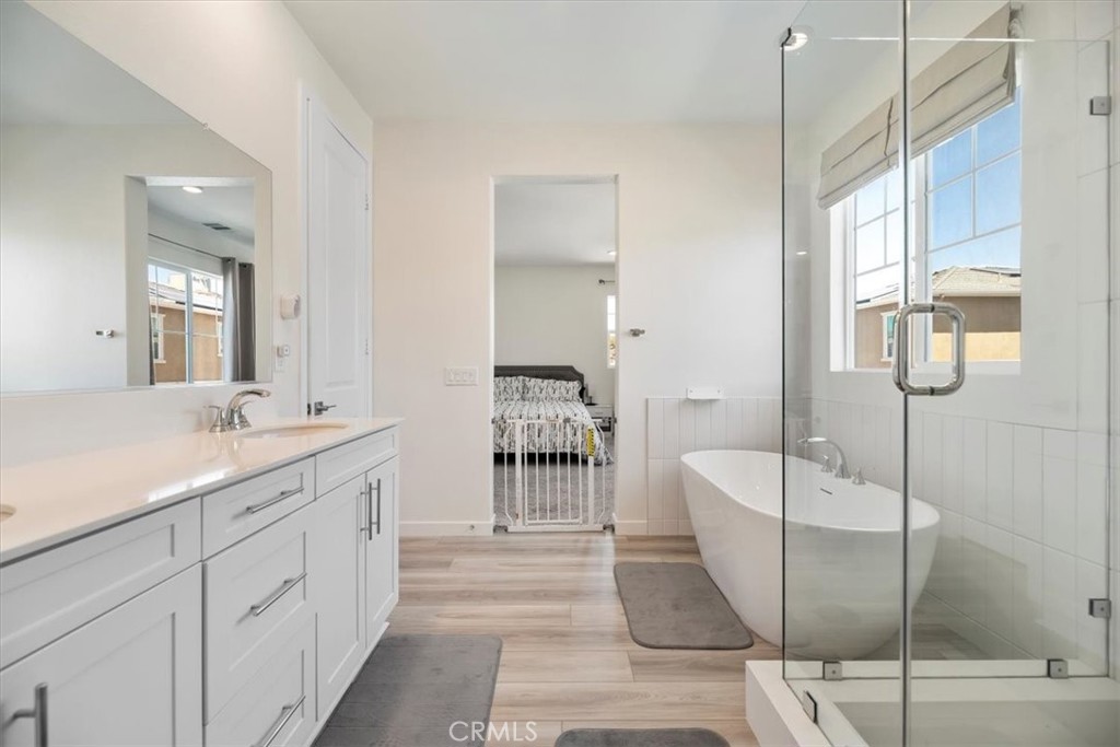 20911 Jennings Way Newhall, CA 91321 - Photo 38 of 47 a en suite bathroom with a double vanity sink a large mirror and a shower