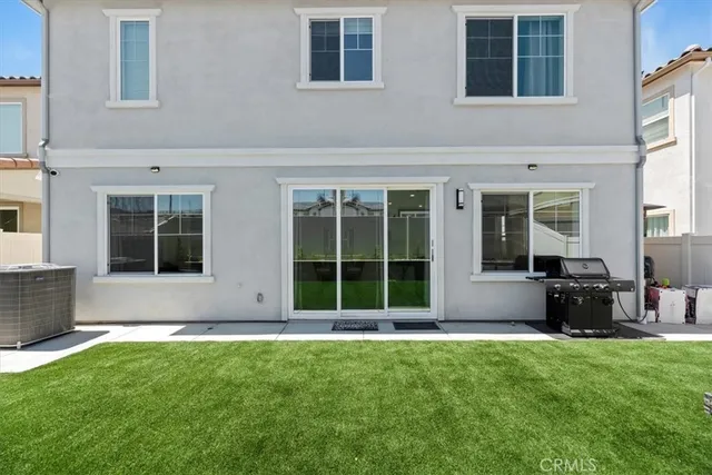 a view of a house with a yard and sitting area