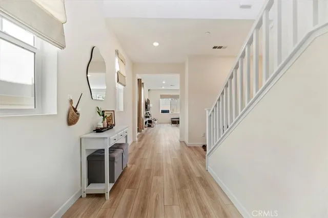 a large white kitchen with stainless steel appliances