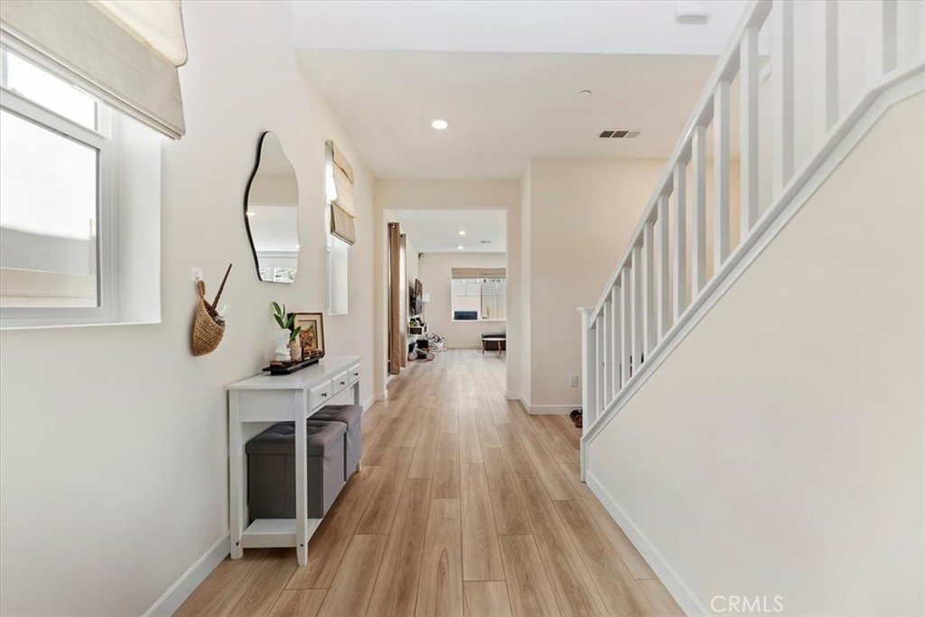 20911 Jennings Way Newhall, CA 91321 - Photo 8 of 47 a view of a hallway with wooden floor fireplace and windows