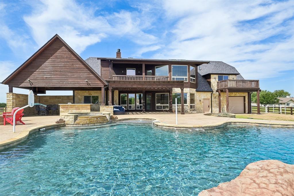 2085 Switzer Road Sanger, TX 76266 - Photo 33 of 39 Expansive backyard featuring a large swimming pool with integrated spa and rock accents