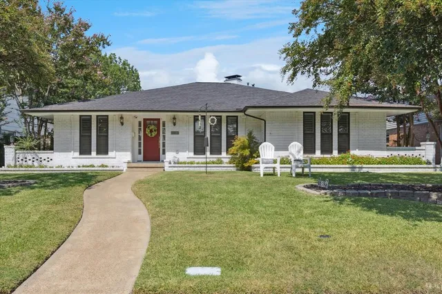 a front view of a house with swimming pool having outdoor seating