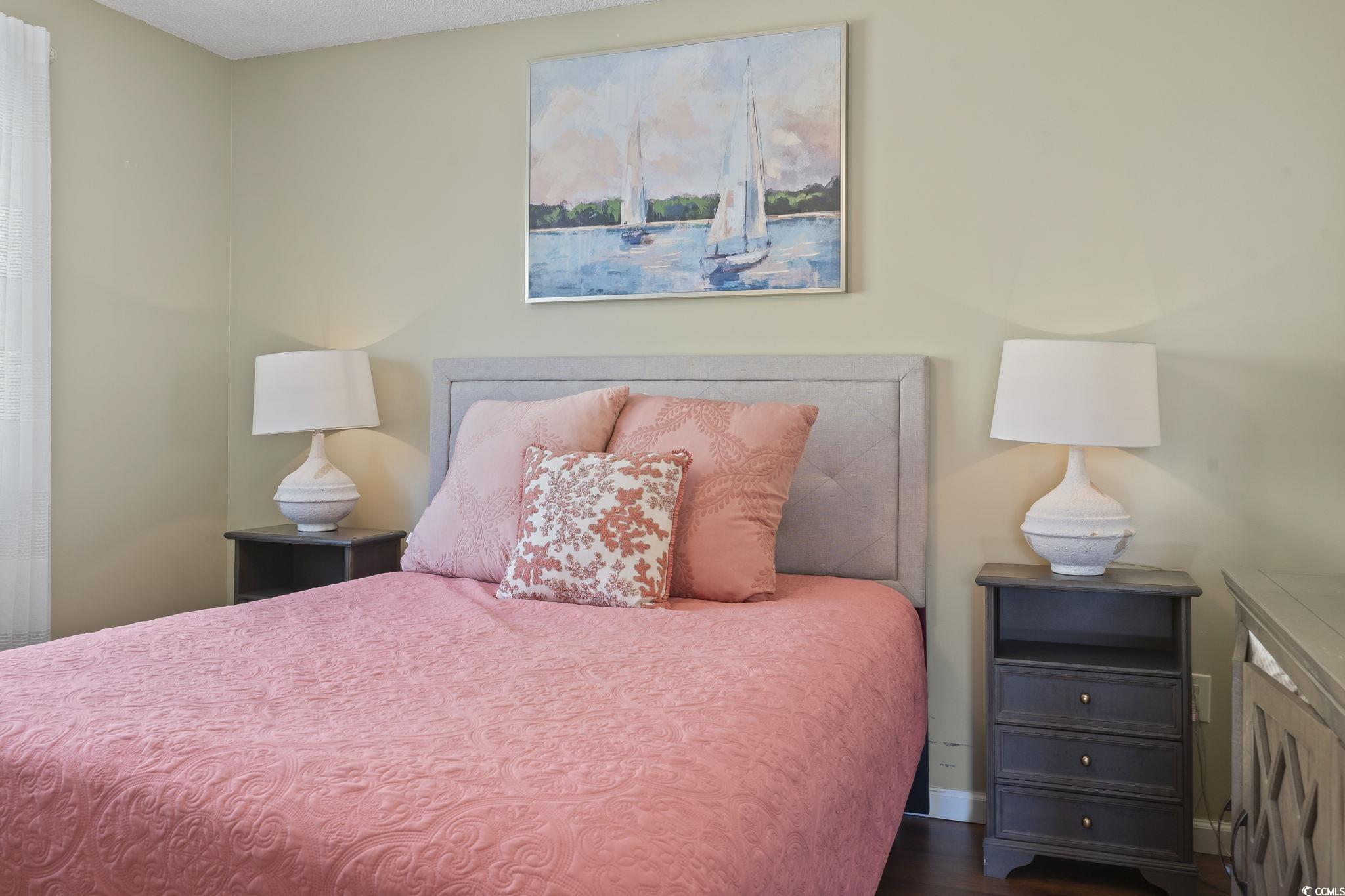 1425 North Waccamaw Drive, Unit 123 Murrells Inlet, SC 29576 - Photo 15 of 39 Bedroom with dark wood-style flooring