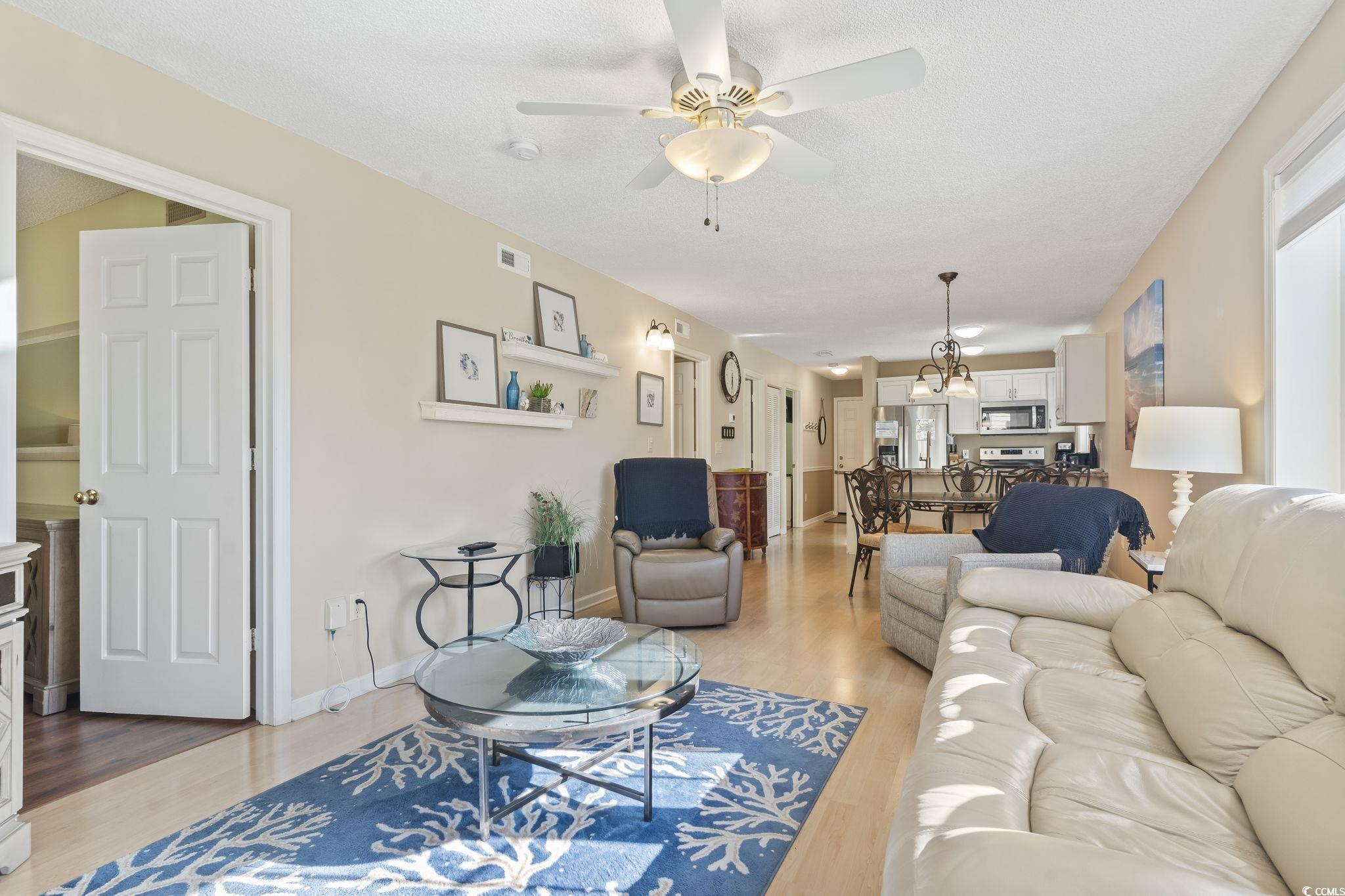 1425 North Waccamaw Drive, Unit 123 Murrells Inlet, SC 29576 - Photo 2 of 39 Living room with light wood-style floors and ceiling fan