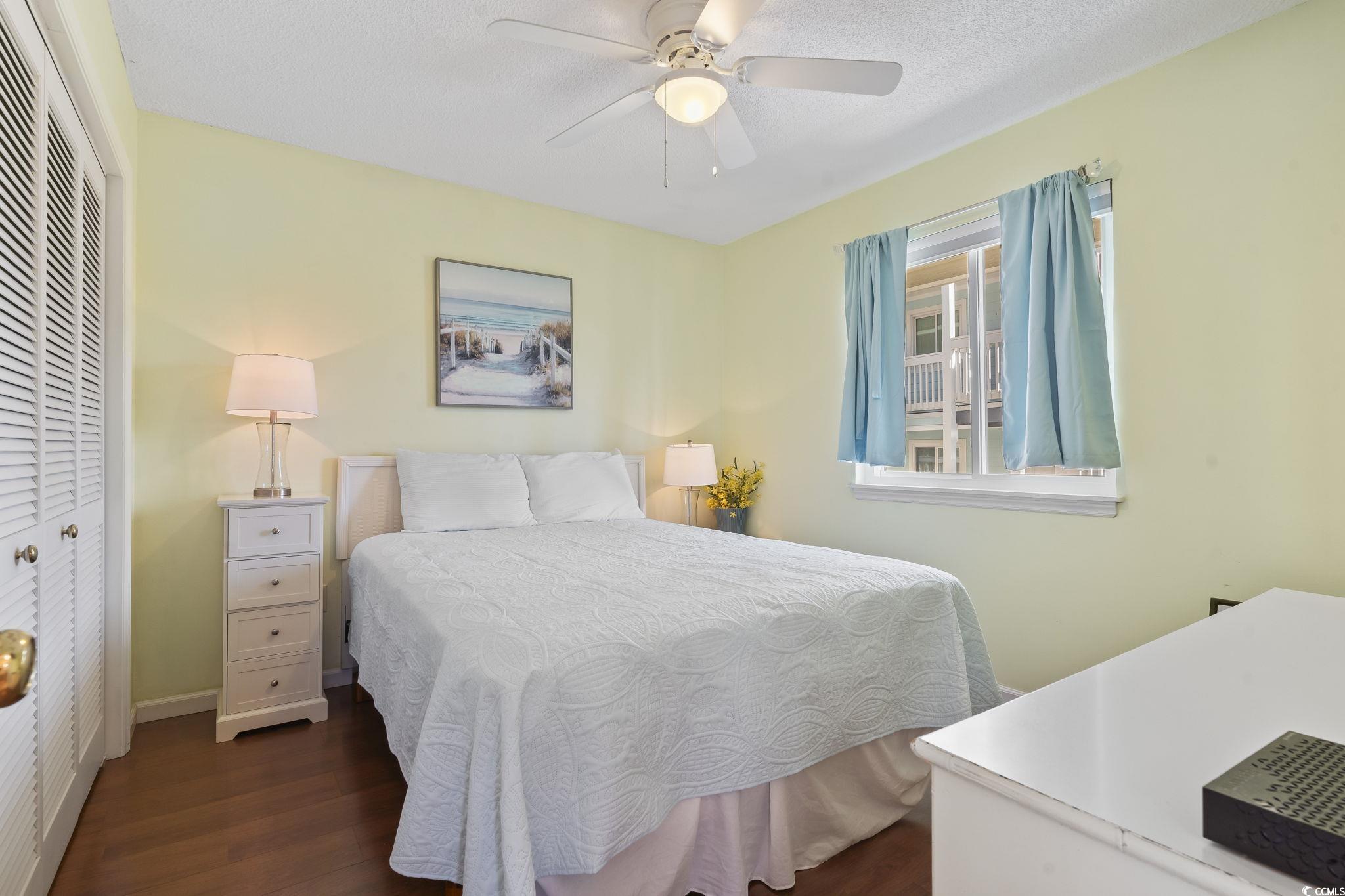 1425 North Waccamaw Drive, Unit 123 Murrells Inlet, SC 29576 - Photo 20 of 39 Bedroom with a closet, dark wood-type flooring, ceiling fan, and a textured ceiling