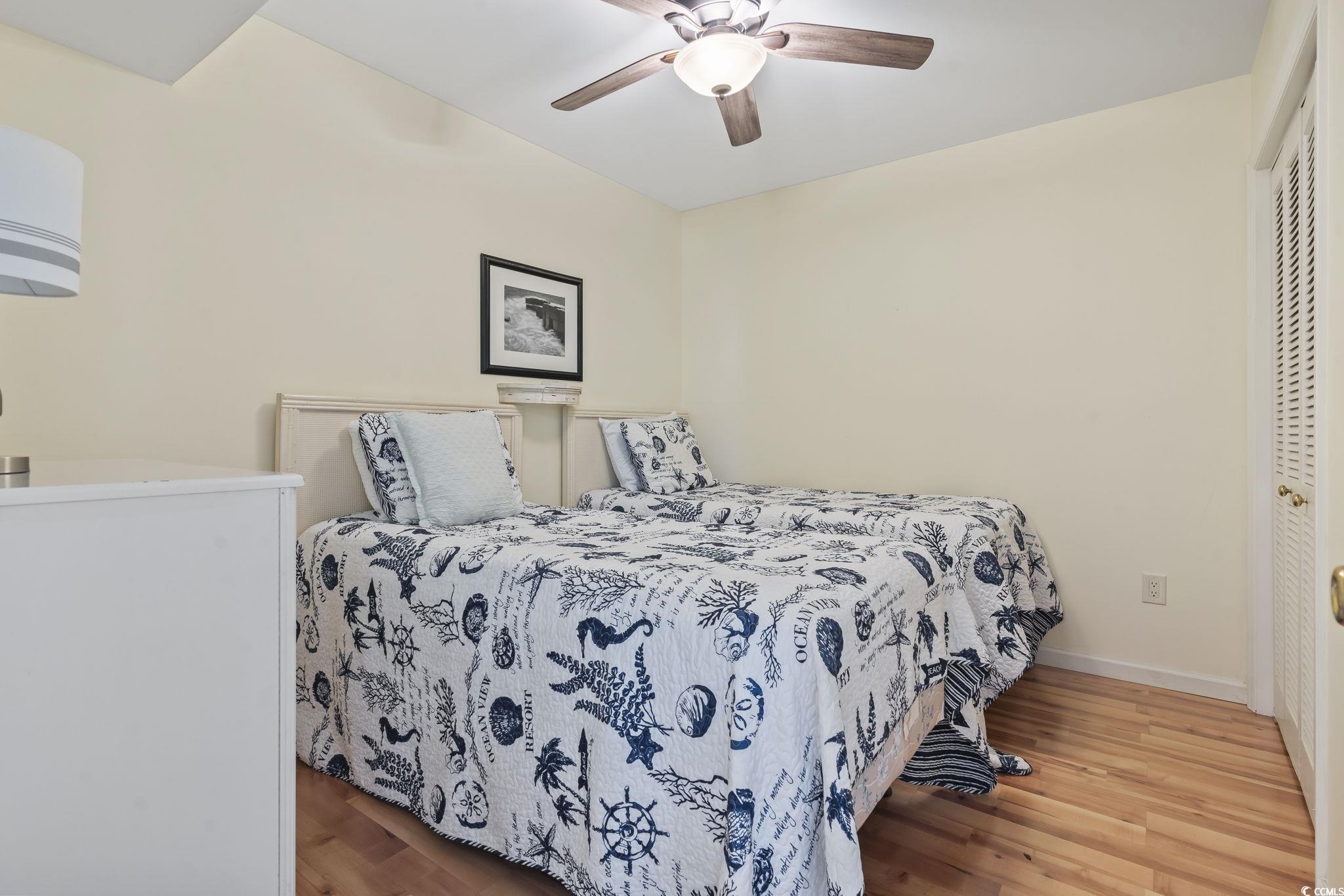 1425 North Waccamaw Drive, Unit 123 Murrells Inlet, SC 29576 - Photo 22 of 39 Bedroom featuring wood finished floors and a ceiling fan