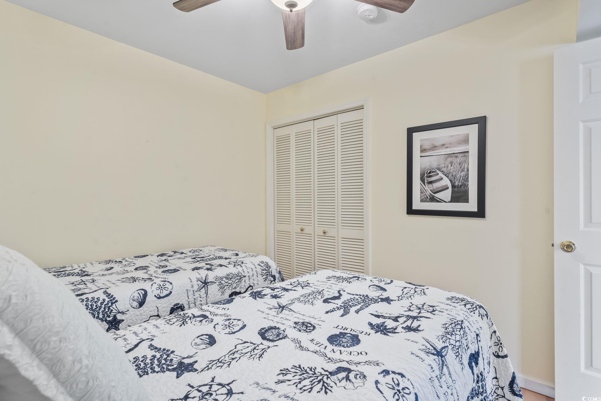 1425 North Waccamaw Drive, Unit 123 Murrells Inlet, SC 29576 - Photo 23 of 39 Bedroom featuring a closet and ceiling fan