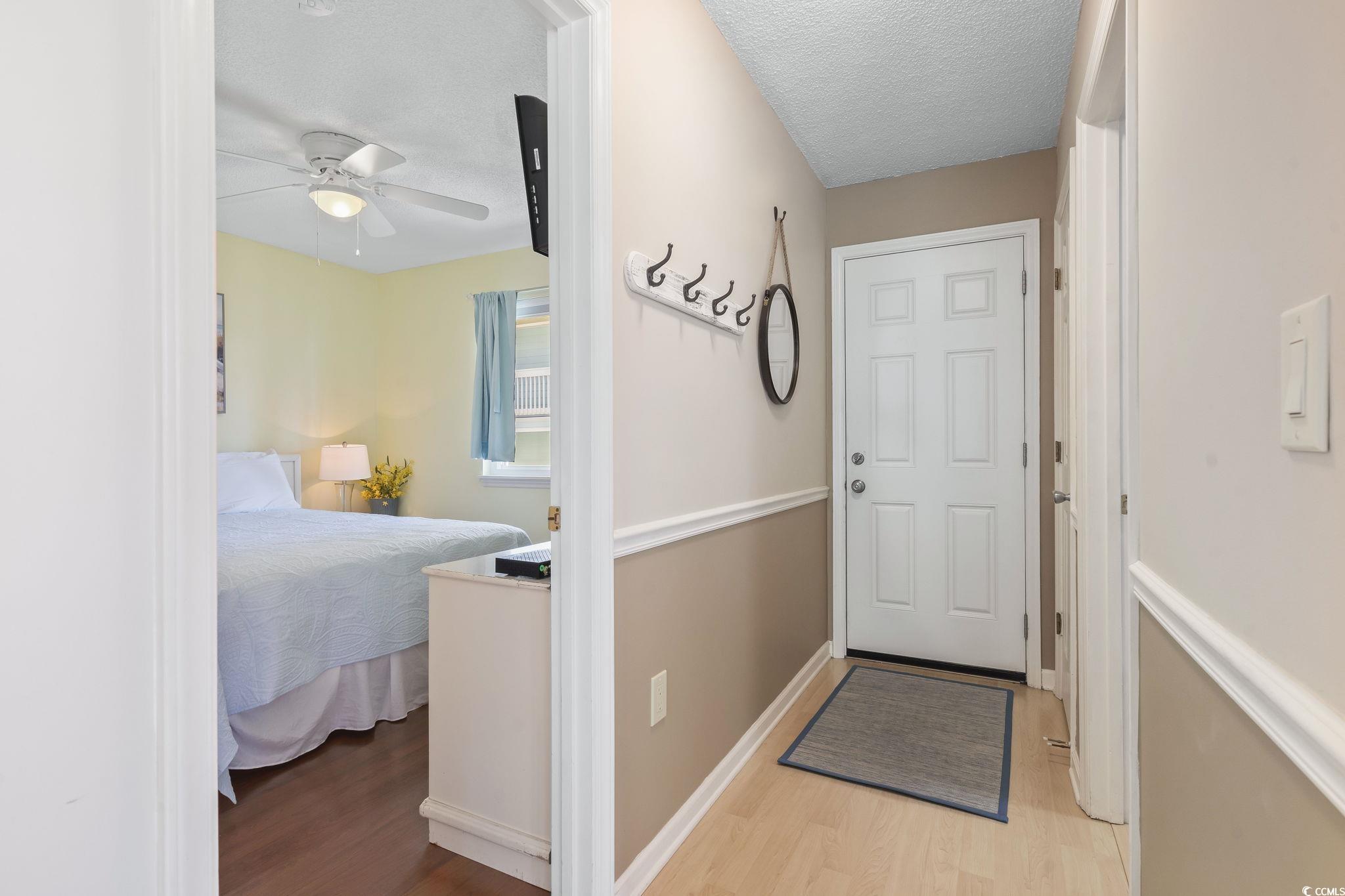 1425 North Waccamaw Drive, Unit 123 Murrells Inlet, SC 29576 - Photo 27 of 39 Entryway with wood finished floors, a textured ceiling, and a ceiling fan