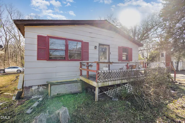 a wooden bench sitting in front of a building