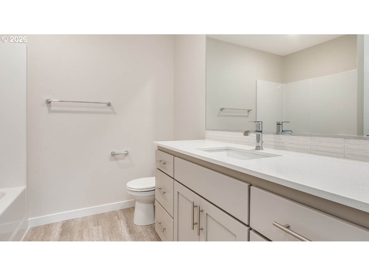 9194 Southeast Azalea Street Happy Valley, OR 97086 - Photo 25 of 32 a bathroom with a sink a toilet and a mirror