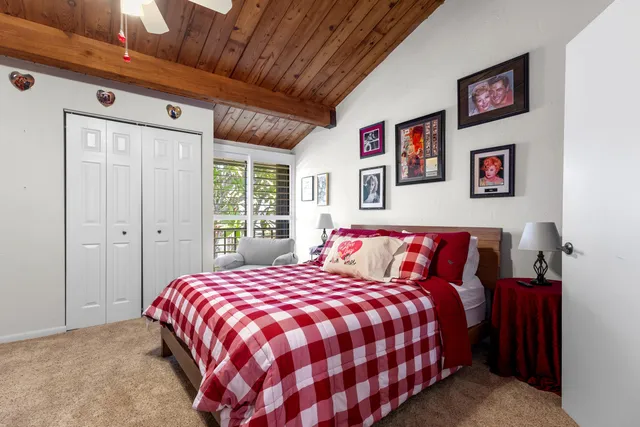 a bedroom with a large bed and a chandelier