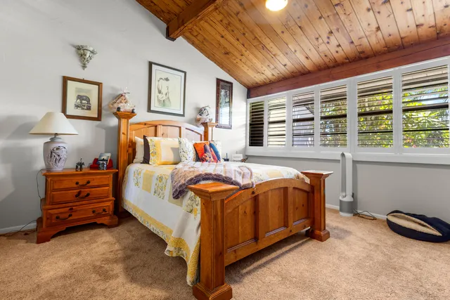 a bed room with a bed and a chair