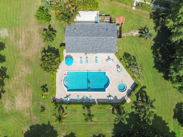 an aerial view of a house with a yard basket ball court and outdoor seating