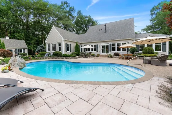 a aerial view of a house with a yard table and chairs