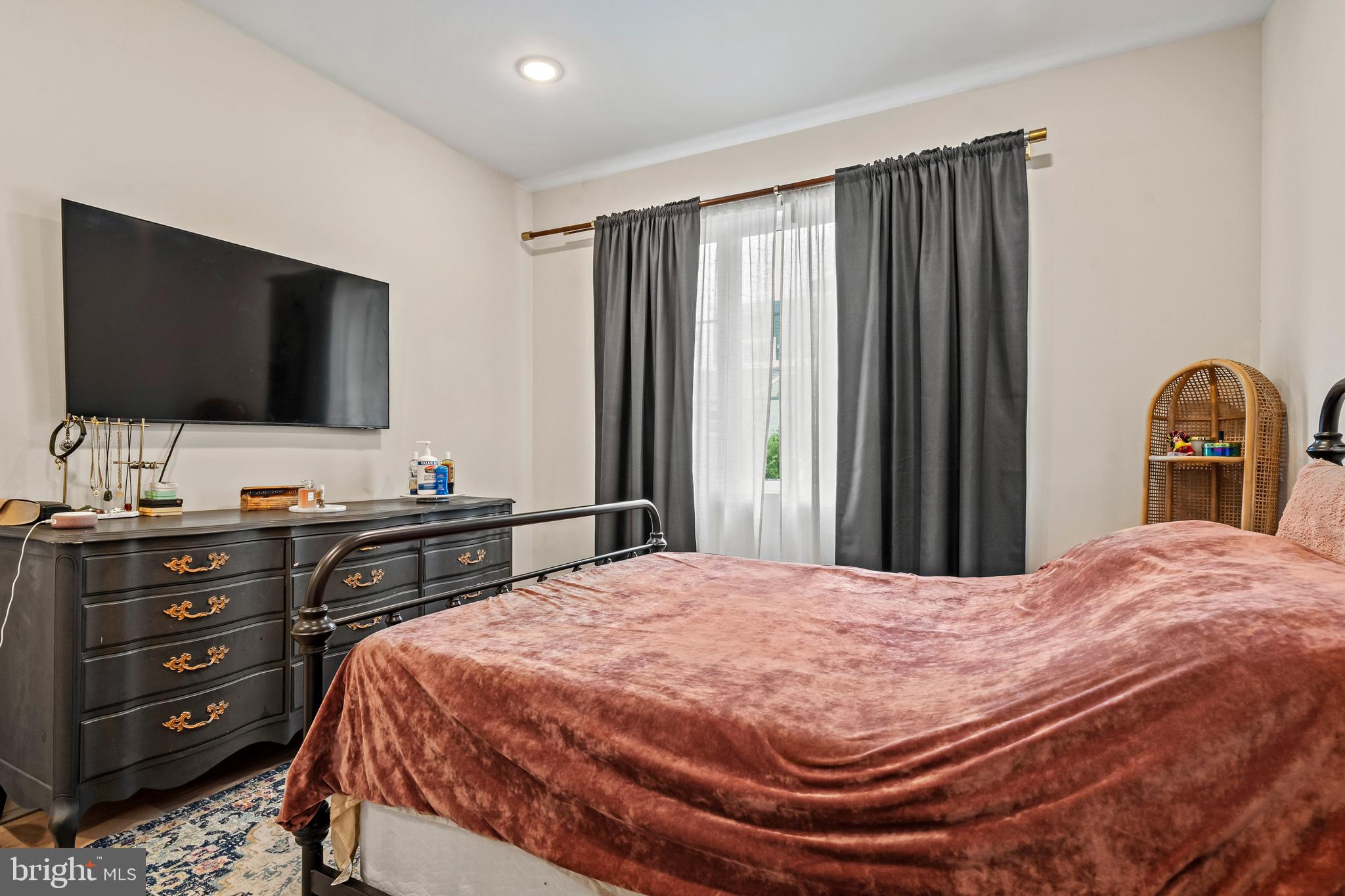1223 Meigs Place Northeast, Unit 101 Washington, DC 20002 - Photo 14 of 22 a bedroom with a bed and a flat screen tv