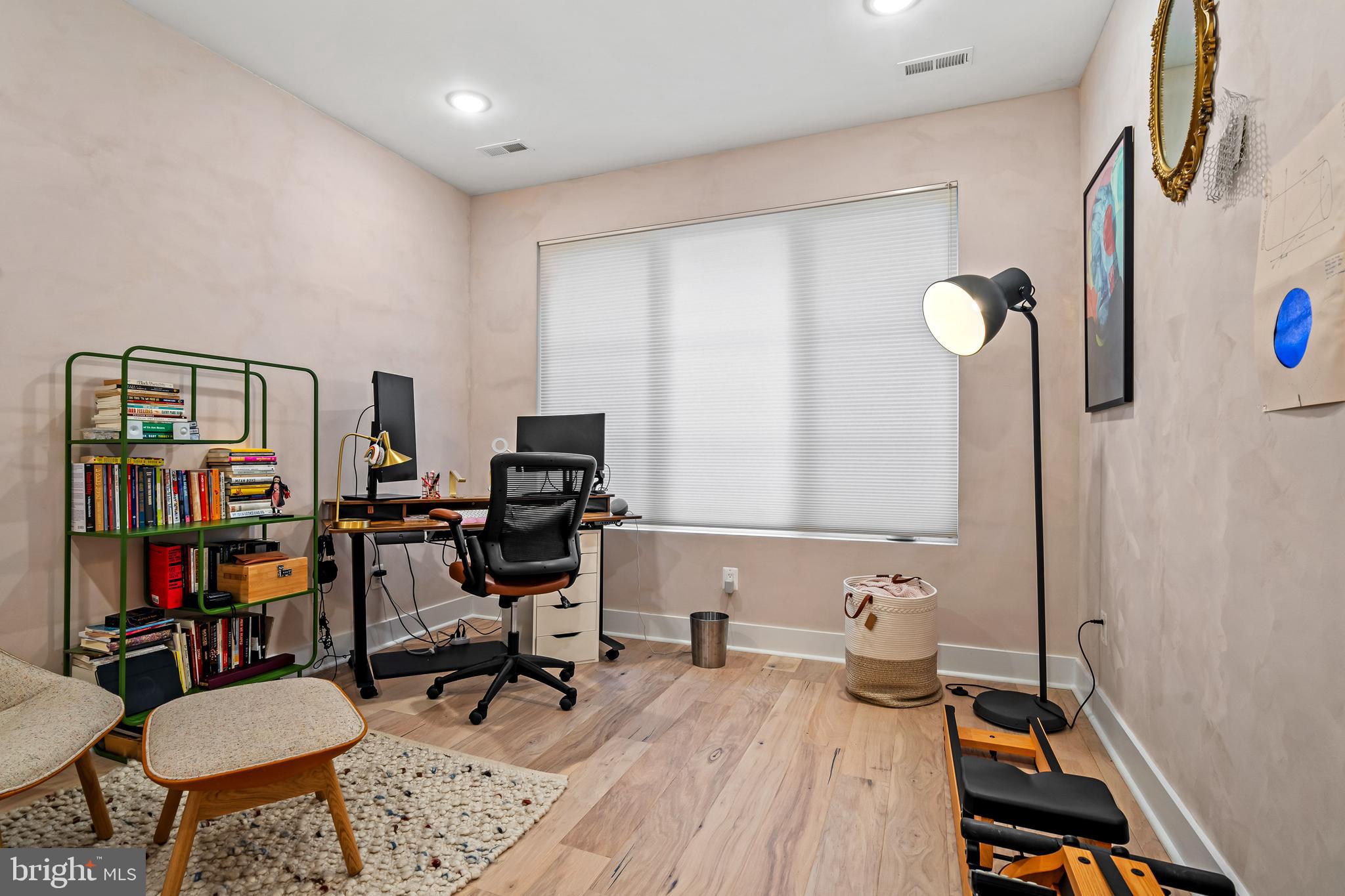 1223 Meigs Place Northeast, Unit 101 Washington, DC 20002 - Photo 5 of 22 a view of a workspace with furniture and a book shelf