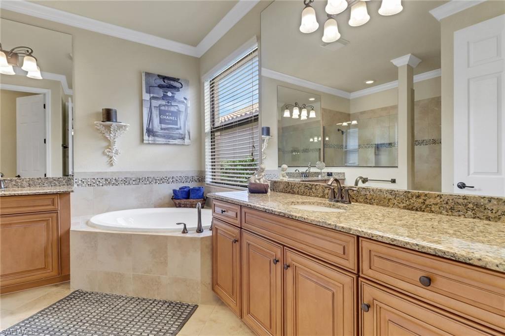 9434 Piacere Way Naples, FL 34113 - Photo 18 of 32 Full bath with a chandelier, vanity, tile patterned floors, tiled shower, and a bath
