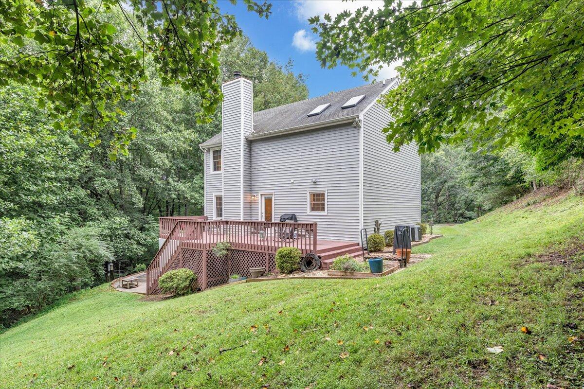 3608 Jae Valley Road Roanoke, VA 24014 - Photo 42 of 51 a view of a backyard with table and chairs and a large tree