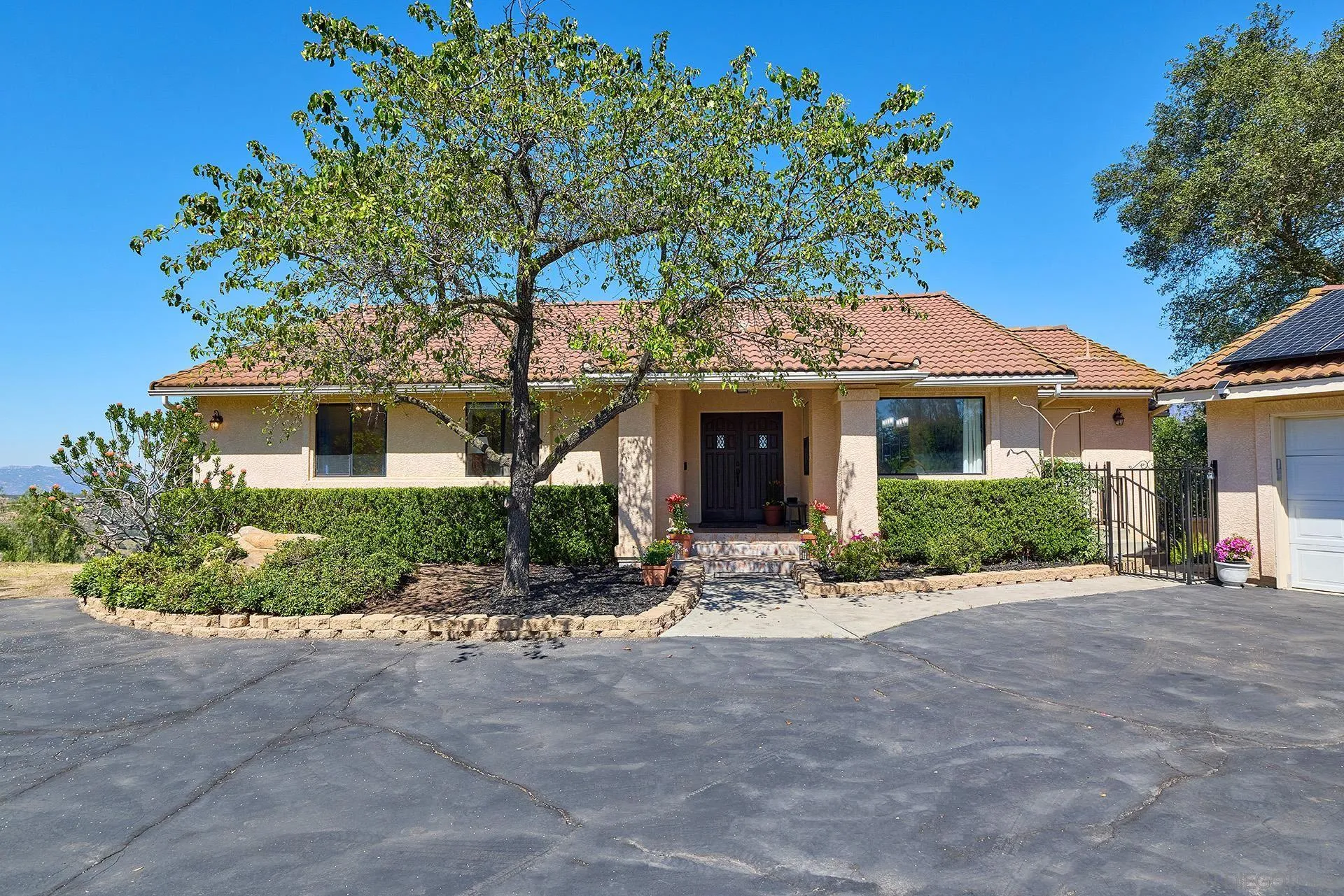 13588 McNally Road Valley Center, CA 92082 - Photo 2 of 43 a front view of a house with a yard and potted plants