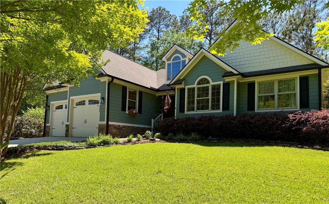 232 Hunters Trail Walhalla, SC 29691 - Photo 2 of 38 This inviting home features a vibrant green exterior and a well-manicured lawn, offering charming curb appeal.