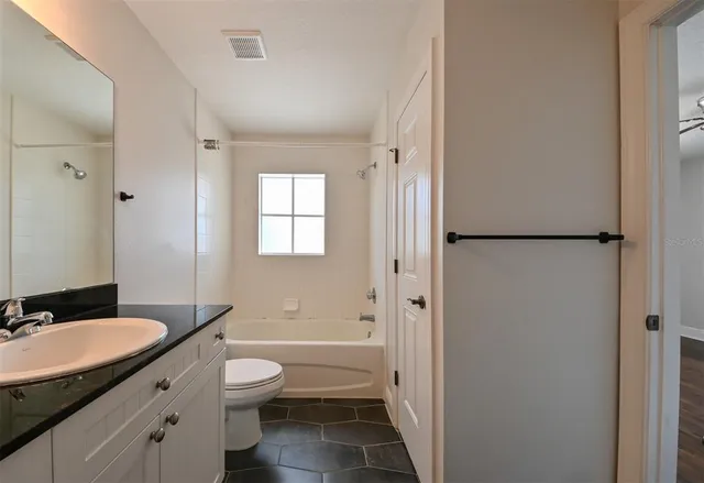 a view of a hallway with wooden floor and closet