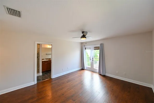 a spacious bathroom with a granite countertop tub double vanity and a mirror