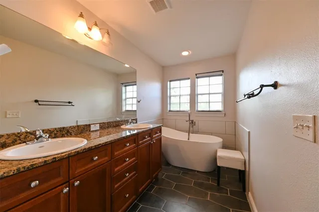 a kitchen with stainless steel appliances kitchen island granite countertop a refrigerator and stove