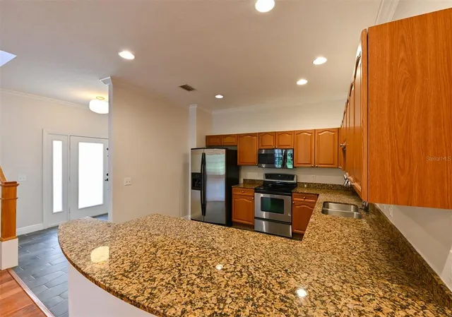 a kitchen with a sink stove top oven and cabinets