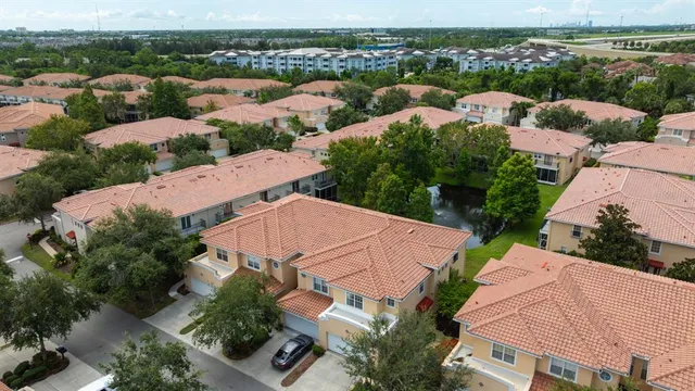 an aerial view of residential houses with outdoor space and river