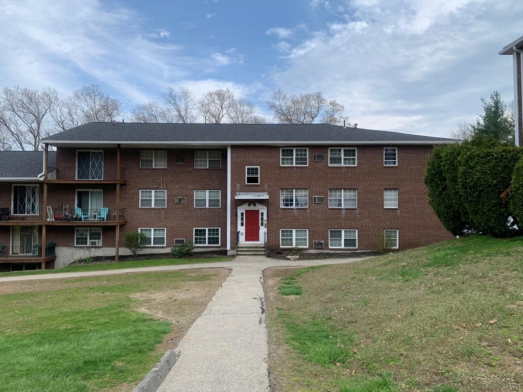 249 Boston Post Road East, Unit 4 Marlborough, MA 01752 - Photo 1 of 11 a front view of a house with a yard