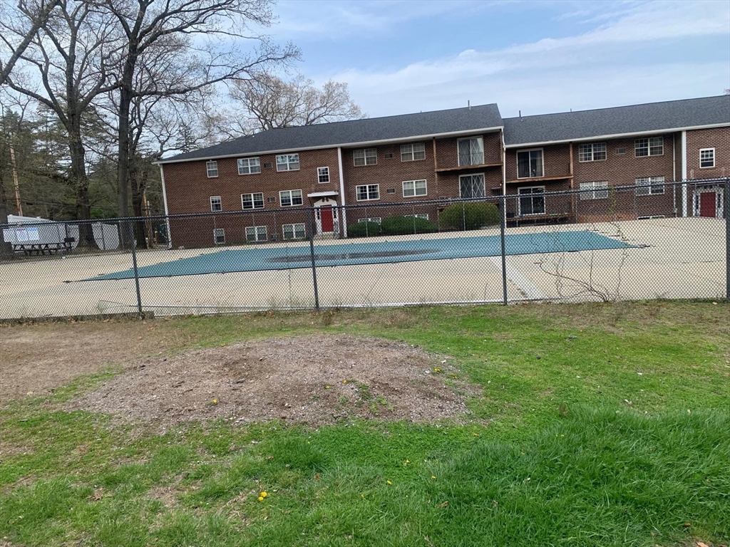 249 Boston Post Road East, Unit 4 Marlborough, MA 01752 - Photo 2 of 11 a view of a house with a yard and a road