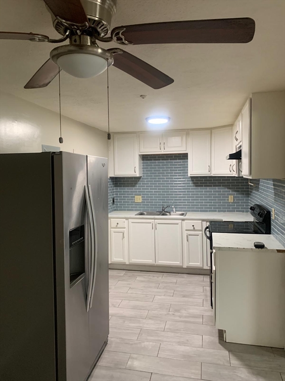249 Boston Post Road East, Unit 4 Marlborough, MA 01752 - Photo 3 of 11 a kitchen with stainless steel appliances granite countertop a refrigerator a sink and white cabinets