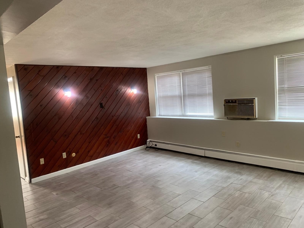 249 Boston Post Road East, Unit 4 Marlborough, MA 01752 - Photo 6 of 11 an empty room with windows