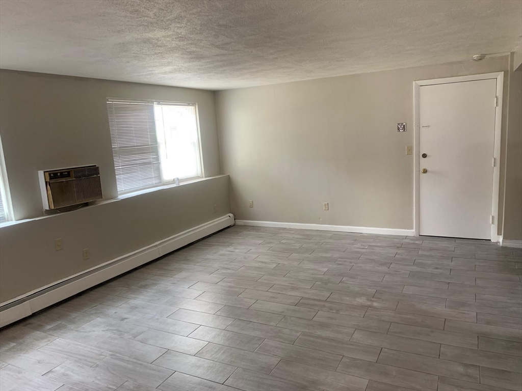 249 Boston Post Road East, Unit 4 Marlborough, MA 01752 - Photo 7 of 11 a view of an empty room with a window