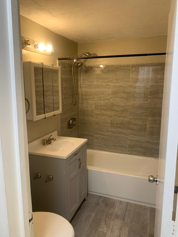 249 Boston Post Road East, Unit 4 Marlborough, MA 01752 - Photo 8 of 11 a bathroom with a sink mirror toilet and bathtub