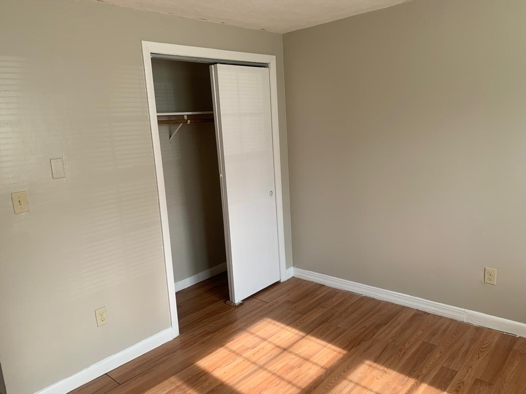 249 Boston Post Road East, Unit 4 Marlborough, MA 01752 - Photo 9 of 11 a view of a room with wooden floor and closet