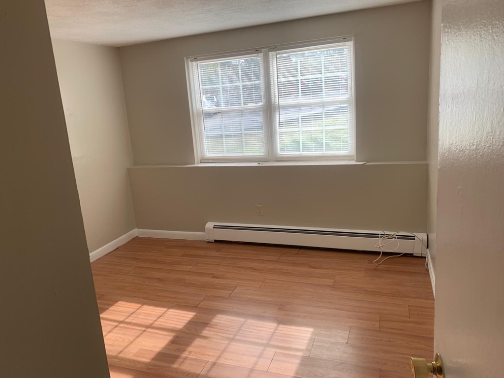 249 Boston Post Road East, Unit 4 Marlborough, MA 01752 - Photo 10 of 11 a view of a room with wooden floor and a window