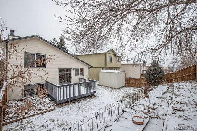 567 James Street Highlands Ranch, CO 80126 - Photo 17 of 17 a view of a house with wooden deck and a chair